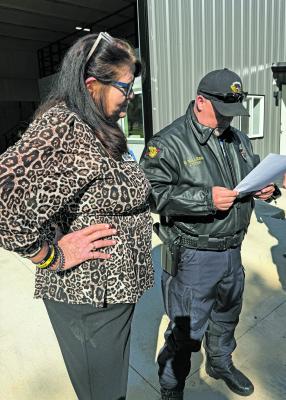 courtesy photo City of Tool Mayor Vera Bennett (left) and Chief of Police Robert Walker look at the petition that was served, concerning a wrongful death lawsuit, involving Tool Police officer Oct 21.