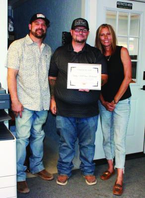 Monitor Photo/Carla Gray Shelly’s McLains owners Caleb Reimers (left) and Shelly Storey are given a certificate of appreciation from Seven Points Mayor Raymond Wennerstrom (center) for their involvement in the Seven Points back to school supply drive held Aug. 1. Certificates were awarded during the council meeting Aug. 27.