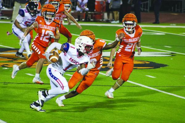 Monitor Photo/Blaine Clamon Camron Booker (No. 6, obscured at center) attempts to tackle an A-Plus runner as teammates Sidney Buchanan (No. 12 at rear, from left) and Riley Roberson (No. 21) converge.