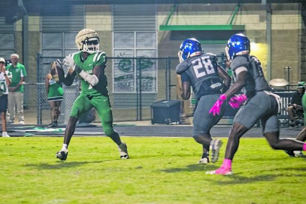 Monitor Photo/Russell Slaton TOP RIGHT: Kerens quarterback Malachi Jordan drops back to pass Oct. 9 as a Frankston defender speeds toward him.