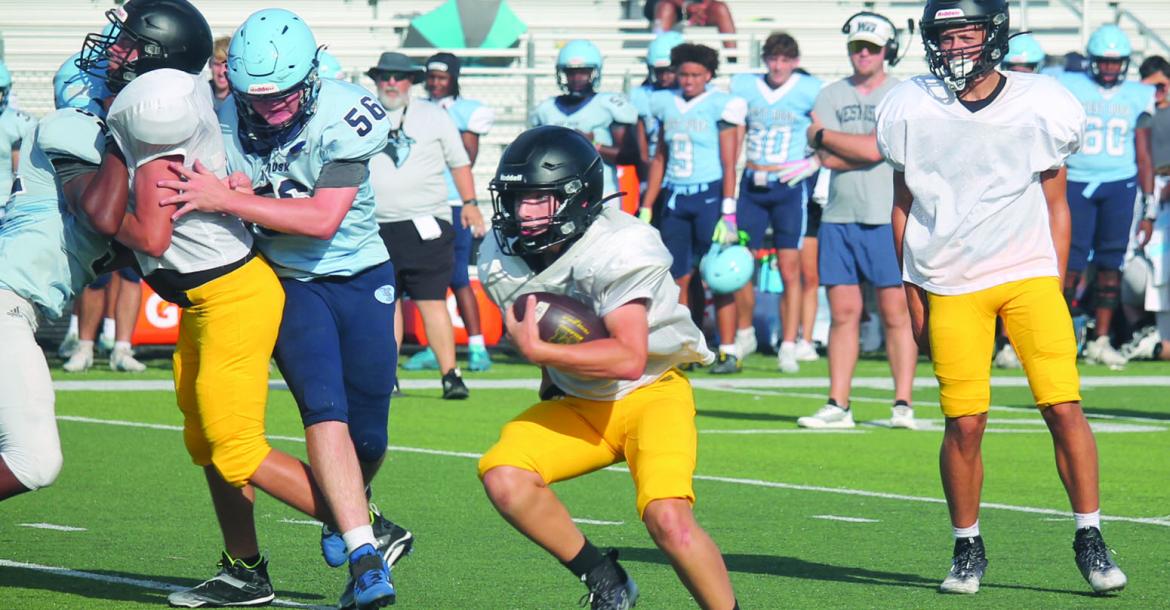 Monitor Photo/Russell Slaton Malakoff Tiger running back Blaise Ryon (center) makes a cut during the Aug. 14 scrimmage hosting West Rusk the first offical weekend of intersquad scrimmages.