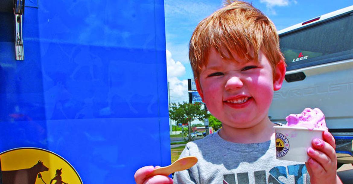 Monitor Photo/Carla Gray Cam Newkirk could not resist a big scoop of strawberry Blue Bell Ice Cream from the Blue Bell Lone Star Scoop Tour July 14.