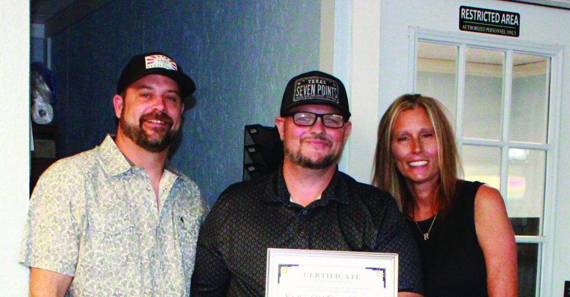 Monitor Photo/Carla Gray Shelly’s McLains owners Caleb Reimers (left) and Shelly Storey are given a certificate of appreciation from Seven Points Mayor Raymond Wennerstrom (center) for their involvement in the Seven Points back to school supply drive held Aug. 1. Certificates were awarded during the council meeting Aug. 27.